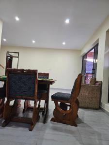 a room with a table and a chair and a bench at Nyanja Cottage in Chembe