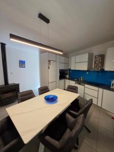 a kitchen with a large white table and chairs at Apartman Andrej in Povlja