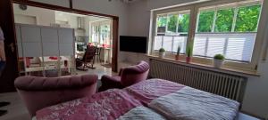 a bedroom with a bed and a living room at Apart Königseiche in Goldenstedt