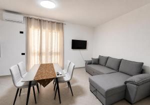 a living room with a couch and a table at Rrapi Apartments in Tragjas