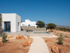 a house in the middle of a desert with a pool at Cycladic home in Paros in Kampos Paros
