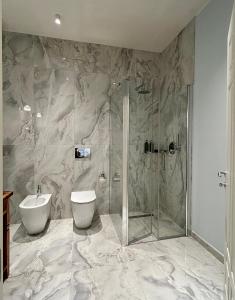 a bathroom with a shower and a toilet and a sink at La PEPITE in Viareggio +59 photos