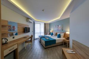 a hotel room with a bed and a desk at Marti Beach Hotel in Kuşadası +121 photos
