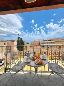 a table with a plate of food on a balcony at Il Sogno di Ulisse in Le Castella +31 photos