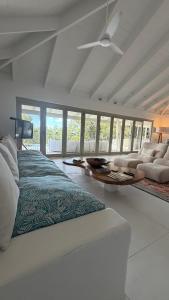 a bedroom with a bed and a couch and a table at Beachfront Peace Cabin in Oak Beach +30 photos