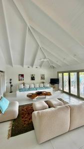 a large living room with a bed and a couch at Beachfront Peace Cabin in Oak Beach