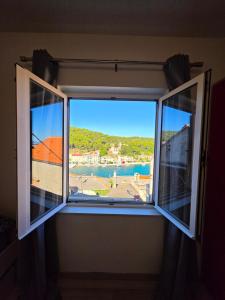 a window with a view of a body of water at Apartman Andrej in Povlja