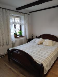 a bedroom with a large bed with a striped blanket at Odpocznij -apartament nad jeziorem in Rydzewo
