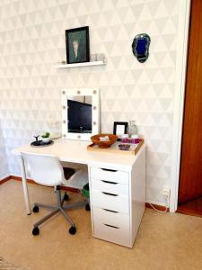 a white desk with a computer on top of it at The Creative Studio Apartment in Piteå