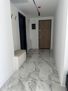 a hallway with a marble floor and a door at Thom Tower in Gonio