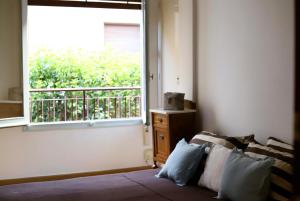 a room with a bed and a window with a balcony at Terraza esquina en el centro in Elche