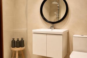 a bathroom with a sink and a mirror and a toilet at Terraza esquina en el centro in Elche +15 photos