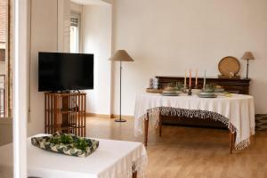 a living room with a table and a television at Terraza esquina en el centro in Elche