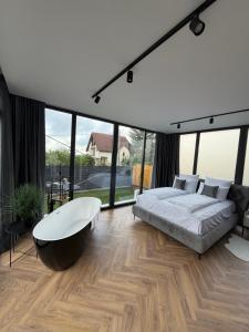 a bedroom with a large bed and a large tub at LUMA Lodge in Sadu +41 photos