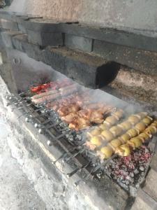 a grill with chickens and other food on it at Syuzn Resort in Goris