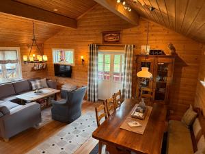 a living room with a couch and a table at Hansmoen in Bjorli +13 photos