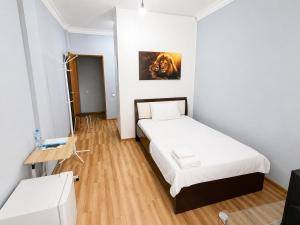 a small room with a bed and a table at Mini Hotel "Arystan" в самом центре столицы in Astana +6 photos