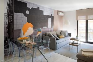 uma sala de estar com uma mesa e um sofá em Eric Vökel Boutique Apartments - BCN Suites em Barcelona