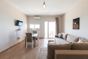 a living room with a couch and a table at Lotus Apartments in Vlorë
