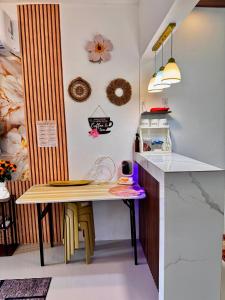a kitchen with a wooden table and a counter at Athena & Storm the Bay Nook in Victoria +7 photos