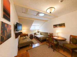 a living room with a couch and a table at Csiszárhegyi Vadászház in Karád