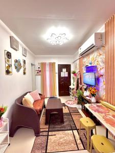 a living room with a couch and a tv at Athena & Storm the Bay Nook in Victoria