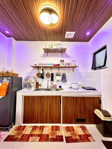 a kitchen with a sink and a refrigerator at Athena & Storm the Bay Nook in Victoria