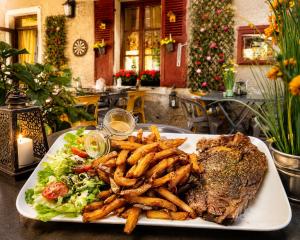 a plate of food with a steak and french fries at Auberge du fromager in Saint-Didier-sur-Doulon +14 photos