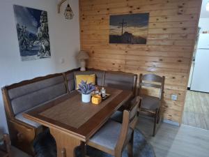 a dining room with a wooden table and chairs at Green cottage in Blidinje