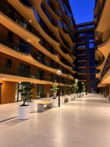 a large building with a hallway with potted plants in it at Royal Luxury Apartaments in Lezhë