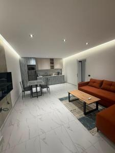 a living room with a couch and a table at Royal Luxury Apartaments in Lezhë