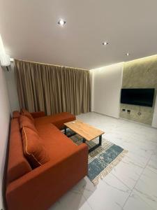 a living room with a couch and a table at Royal Luxury Apartaments in Lezhë