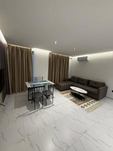 a living room with two tables and a couch at Royal Luxury Apartaments in Lezhë +5 photos