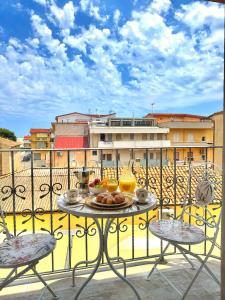 a table with a plate of food on a balcony at Il Sogno di Ulisse in Le Castella