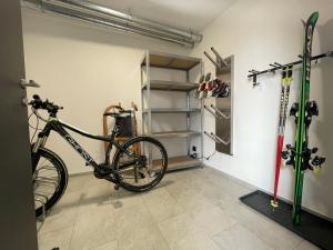 a bike parked in a room with ski equipment at MAVI Apartment in Schlitters