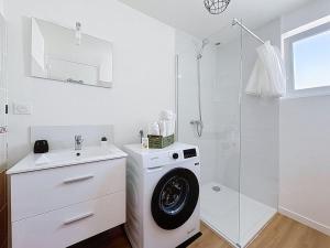 a white bathroom with a washing machine and a shower at 8A - Le Nid in Saint-Rambert-dʼAlbon