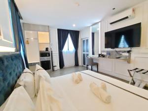 a hotel room with a bed and a kitchen at Frazel Heritage Hotel in Alor Setar