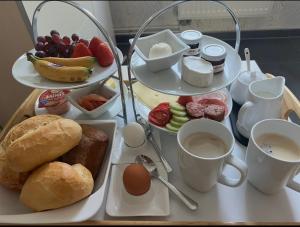 a tray of breakfast foods and coffee on a table at Ferienwohnung zur Apotheke in Hessen