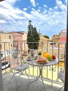 a table with food on top of a balcony at Il Sogno di Ulisse in Le Castella