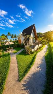 a house with a gravel road in front of it at Lombok Hidden Villa in Tetebatu