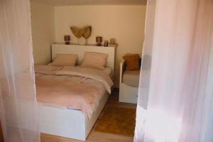 a bedroom with a bed with a white headboard at Statek ráj Netvořice, Tiny house and Farm Experience in Netvořice