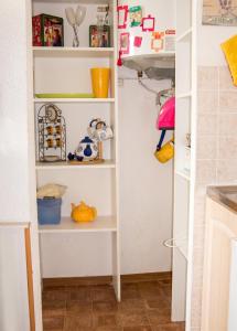 a kitchen pantry with white shelves at Studio confortable à Valras-Plage de 26 m² in Valras-Plage +6 photos