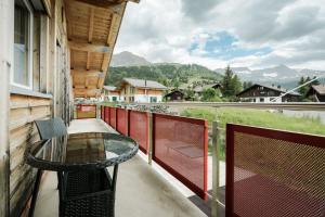 a balcony with a glass table and a view at Bergchalet mit Panoramablick nahe Brienz in Axalp