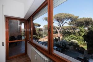 a window in a house with a view of a yard at ArticOstia in Lido di Ostia