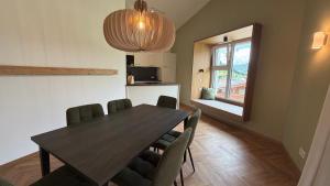 a dining room with a wooden table and chairs at Mountain Inn - Hochquartier - Wildschönau in Niederau