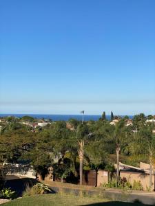 a view of the ocean from a park with trees at The Willow Escape in Ballito
