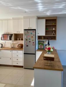 a kitchen with a refrigerator with magnets on it at The Willow Escape in Ballito
