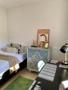 a bedroom with a bed and a desk with a table at The Willow Escape in Ballito