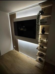 a living room with a flat screen tv on a wall at Le Nid douillet- Studio Chic au cœur Issoire in Issoire +1 photo