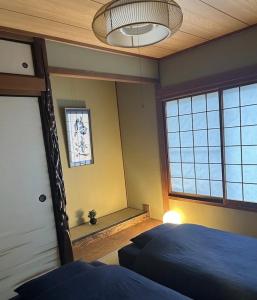 a bedroom with a bed and a large window at Hirakata house, Easy Access to Kyoto and Osaka in Hirakata +28 photos